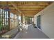 Covered patio with stone floors, offering an outdoor seating area, ideal for relaxation with waterfront views at 4446 Bahama Dr, Hernando Beach, FL 34607