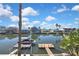 Beautiful waterfront homes on a sunny day with a boat dock offering stunning views at 4446 Bahama Dr, Hernando Beach, FL 34607
