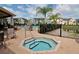 Resort-style community pool featuring jacuzzi, seating, palm trees, and views of neighboring homes at 5520 Rosehill Rd # 201, Sarasota, FL 34233