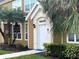 Front entryway with a well-lit doorway, complemented by lush, manicured landscaping at 5520 Rosehill Rd # 201, Sarasota, FL 34233
