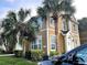 Charming two-story condo with neutral siding, white trim, and manicured landscaping at 5520 Rosehill Rd # 201, Sarasota, FL 34233