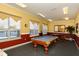 Community game room featuring a pool table, comfortable seating, and natural light at 5520 Rosehill Rd # 201, Sarasota, FL 34233