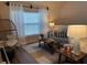 Living room with comfy sofa, egg chair, wood-look flooring, and lots of light at 5520 Rosehill Rd # 201, Sarasota, FL 34233