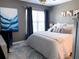 Bedroom featuring decorative pillows, modern lighting, and a large window at 5520 Rosehill Rd # 201, Sarasota, FL 34233