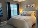 Bedroom featuring decorative pillows, modern lighting, and a view of outside at 5520 Rosehill Rd # 201, Sarasota, FL 34233