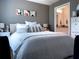 Bedroom featuring decorative pillows, modern lighting, with a peek into a bathroom at 5520 Rosehill Rd # 201, Sarasota, FL 34233
