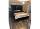 Bedroom featuring a platform bed with dark wood flooring at 4939 Marina Palms Dr, Port Richey, FL 34668