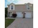 Charming two-story townhouse with attached garages and a brick driveway at 4939 Marina Palms Dr, Port Richey, FL 34668
