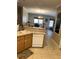 Kitchen with wooden cabinets, white appliances and view of dining area at 4939 Marina Palms Dr, Port Richey, FL 34668