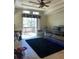 Relaxing living room with reclining chairs and sliding glass door to balcony at 4939 Marina Palms Dr, Port Richey, FL 34668