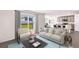 Bright living room showcasing large window, contemporary furniture, and open floor plan at 30926 Silver Stage Dr, Brooksville, FL 34602