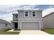 Charming two-story home featuring a two-car garage and a well-manicured lawn at 30934 Silver Stage Dr, Brooksville, FL 34602