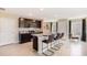 Modern kitchen with dark cabinets, stainless appliances, granite counters and seating at the island at 30934 Silver Stage Dr, Brooksville, FL 34602