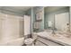 Modern bathroom featuring a shower-tub combo, marble countertops, and blue-grey wall paint at 5064 Roble Ave, Spring Hill, FL 34606