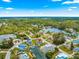 Wide aerial view of the home and community with canal access and a beautiful tree line at 6771 Seaview Blvd, Hudson, FL 34667