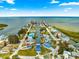 Aerial view of a coastal community, with teal and blue houses built alongside canals, and the sea in the background at 6771 Seaview Blvd, Hudson, FL 34667