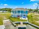 Backyard with a wooden dock, a small outdoor tub, and a fire pit in a fenced yard at 6771 Seaview Blvd, Hudson, FL 34667