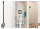 Bright bathroom featuring neutral paint, a shower with pebble floor, a towel rack, and white fixtures at 6771 Seaview Blvd, Hudson, FL 34667