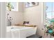 Elegant bathroom featuring a freestanding tub, bamboo tray, and floral decor at 6771 Seaview Blvd, Hudson, FL 34667