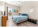 Comfortable bedroom with a wooden bed frame, wood floors, and a large window at 6771 Seaview Blvd, Hudson, FL 34667