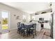 Dining area with access to the outdoor deck, adjacent to a kitchen with white cabinets at 6771 Seaview Blvd, Hudson, FL 34667