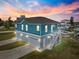 Multi-level exterior with three garage spaces, staircase, and waterfront view at 6771 Seaview Blvd, Hudson, FL 34667