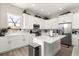 Modern kitchen with white cabinets, stainless steel appliances, and light countertops at 6771 Seaview Blvd, Hudson, FL 34667
