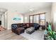 Open living room with a large leather sectional, natural light, and neutral color palette at 6771 Seaview Blvd, Hudson, FL 34667