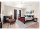Spacious bedroom with a chaise lounge, wood floors, and comfortable furnishings at 6771 Seaview Blvd, Hudson, FL 34667