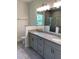 Bathroom featuring dual vanities with granite countertops, tile flooring, and decorative light fixtures at 1608 Alliance Ave, North Port, FL 34286