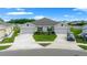 Attractive home featuring well-maintained landscaping, an attached two-car garage, and a convenient circular driveway at 17663 Turning Leaf Cir, Land O Lakes, FL 34638