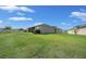 A spacious backyard with green grass surrounding the house, offering plenty of space for outdoor activities at 17663 Turning Leaf Cir, Land O Lakes, FL 34638