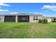 A well-maintained backyard featuring lush green grass and a screened-in porch area for outdoor enjoyment at 17663 Turning Leaf Cir, Land O Lakes, FL 34638