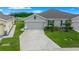 Charming single-story home with a well-manicured lawn and attached two-car garage at 17663 Turning Leaf Cir, Land O Lakes, FL 34638