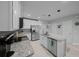 Bright kitchen featuring stainless steel appliances, granite countertops, tile backsplash and white cabinets at 17663 Turning Leaf Cir, Land O Lakes, FL 34638