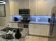 Bright kitchen with white cabinetry, granite counters, mosaic backsplash, and stainless appliances at 17663 Turning Leaf Cir, Land O Lakes, FL 34638