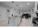 Kitchen island featuring bar seating, stainless steel appliances, and a sink with white cabinets at 17663 Turning Leaf Cir, Land O Lakes, FL 34638