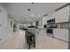 Bright, open kitchen features stainless appliances, granite countertops, a tile backsplash, and island with seating at 17663 Turning Leaf Cir, Land O Lakes, FL 34638