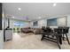 Inviting open-concept living area with a comfortable sectional sofa and stylish dining table at 17663 Turning Leaf Cir, Land O Lakes, FL 34638