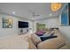 Bright and airy living room featuring a plush sectional couch, TV, and plenty of seating at 17663 Turning Leaf Cir, Land O Lakes, FL 34638