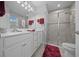 Main bathroom featuring a double vanity, tile flooring and a glass enclosed walk-in shower at 17663 Turning Leaf Cir, Land O Lakes, FL 34638