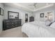 Comfortable main bedroom with carpet flooring, ensuite bathroom, and a dresser with a large mirror at 17663 Turning Leaf Cir, Land O Lakes, FL 34638