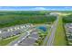 An aerial view showcases a beautiful neighborhood near a lush, green forest at 17663 Turning Leaf Cir, Land O Lakes, FL 34638