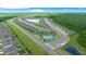 Aerial view features a new neighborhood with community ponds, lush landscaping and green forests at 17663 Turning Leaf Cir, Land O Lakes, FL 34638