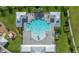 Aerial view of a community pool area with a large pool, lounge chairs, and covered seating at 17663 Turning Leaf Cir, Land O Lakes, FL 34638