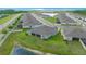 Aerial view displays a screened in lanai with a pond view and a well maintained lawn at 17663 Turning Leaf Cir, Land O Lakes, FL 34638
