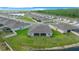 An aerial view showcases the backyard with a screened-in porch and a lush pond view at 17663 Turning Leaf Cir, Land O Lakes, FL 34638