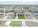 Aerial view of a single Gathering home featuring a large front lawn, two car garage and mature landscaping at 4196 Hoffman Ave, Spring Hill, FL 34606