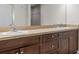Bathroom featuring dual sinks, granite counters and updated dark wood cabinetry at 4196 Hoffman Ave, Spring Hill, FL 34606