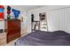 Bedroom with closet, dresser, and a bed with blue linens, suitable for relaxation and rest at 4196 Hoffman Ave, Spring Hill, FL 34606